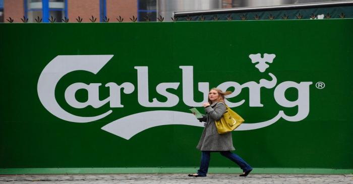 A woman walks past the Tetley's brewery in Leeds, northern England