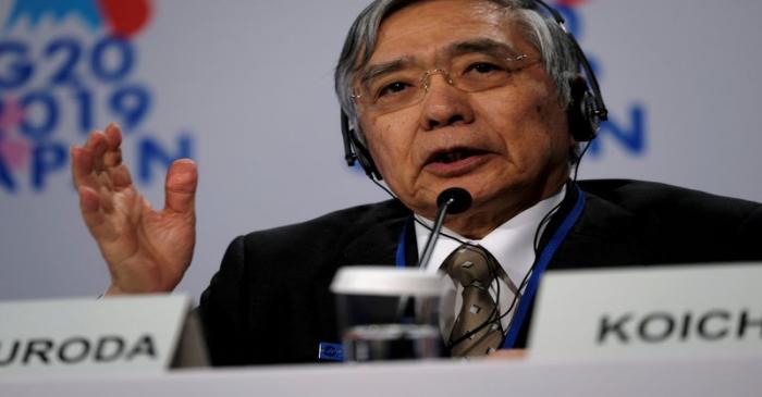 FILE PHOTO: Bank of Japan Governor Haruhiko Kuroda takes questions from reporters at the annual