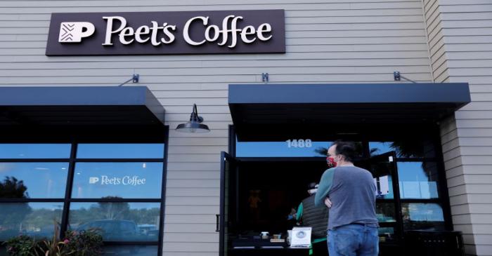 Customers wear masks as they wait in line at a Peet's coffee shop in Encinitas, California