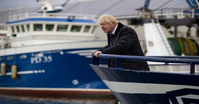 FILE PHOTO: Britain's Prime Minister Boris Johnson is seen aboard the Opportunus IV fishing