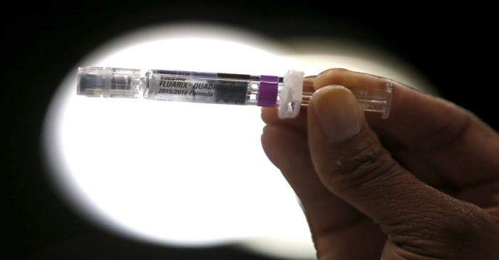 FILE PHOTO: A nurse displays a flu vaccine at a free medical and dental health clinic in Los