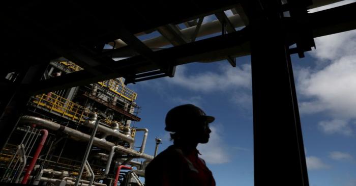 FILE PHOTO: A worker walks inside the Brazil's Petrobras P-66 oil rig in the offshore Santos