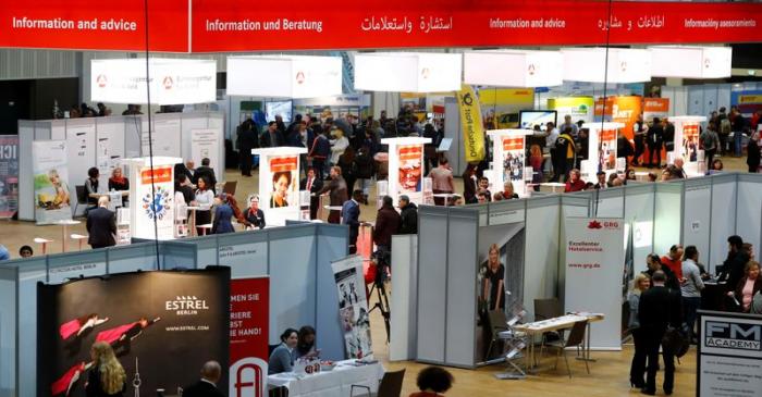 Visitors attend a job fair for migrants in Berlin