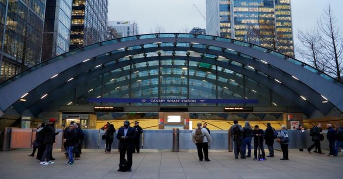 Commuters are seen outside a closed Canary Wharf tube station following an incident at the