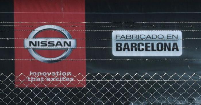 The logo of Nissan is seen through a fence at Nissan factory at Zona Franca during the