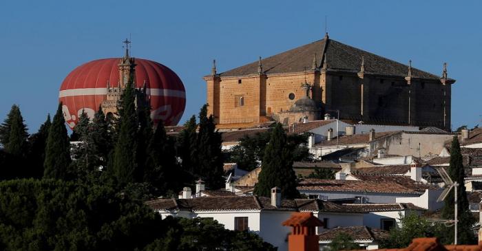 A hot air balloon with the logo of German energy giant E.ON flies at dawn in Ronda