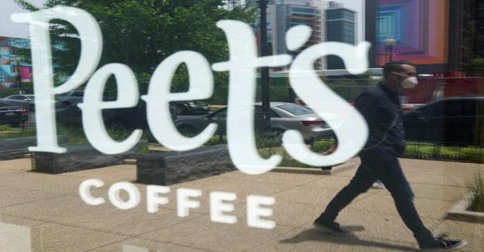 FILE PHOTO: A man passes a Peet's coffee shop in Washington, USA