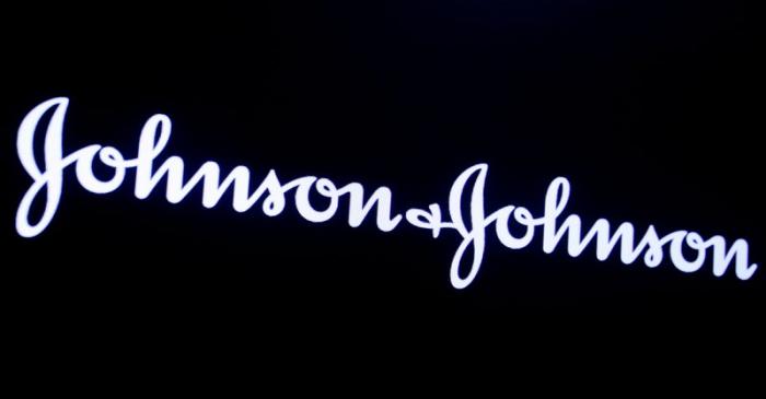 The company logo for Johnson & Johnson is displayed on a screen to celebrate the 75th
