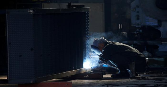 FILE PHOTO: A man works at a factory at the Keihin industrial zone in Kawasaki