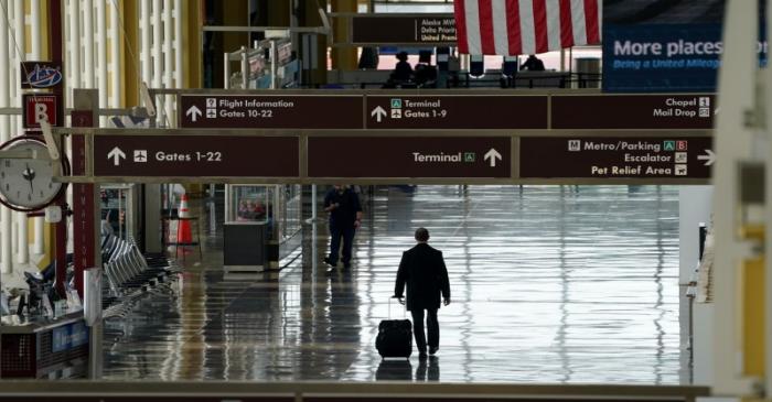 FILE PHOTO: Lone passenger walks through Reagan National airport in Washington
