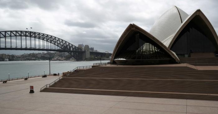 FILE PHOTO: People are seen on the nearly deserted steps of the Sydney Opera House