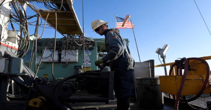 FILE PHOTO: A worker operates equipment on a drilling rig near Midland