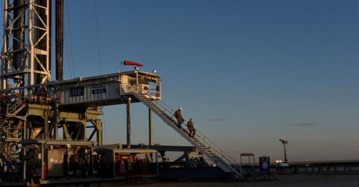 FILE PHOTO: A drilling crew leaves the rig at the end of their shift on a lease owned by