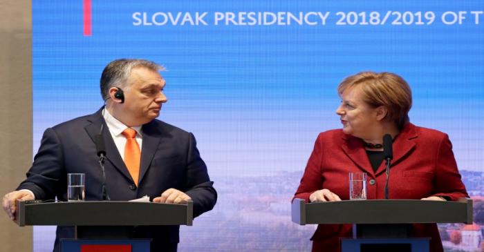 FILE PHOTO: German Chancellor Angela Merkel speaks to Hungarian Prime Minister Viktor Orban