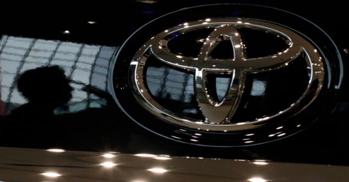 FILE PHOTO: A visitor is reflected on a Toyota car at the company's showroom in Tokyo