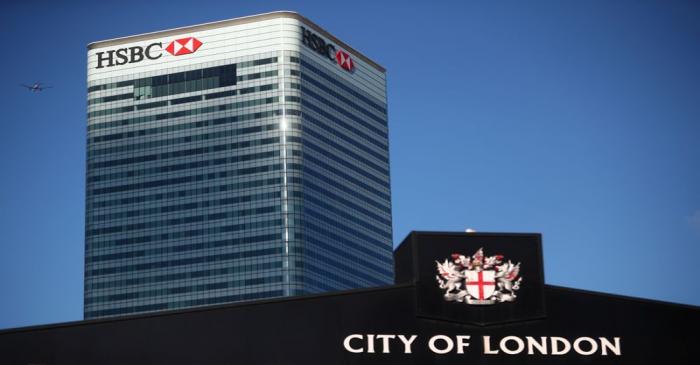 HSBC's building in Canary Wharf is seen behind a City of London sign outside Billingsgate