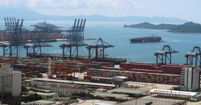 FILE PHOTO: Cargo ship carrying containers is seen near the Yantian port in Shenzhen, following