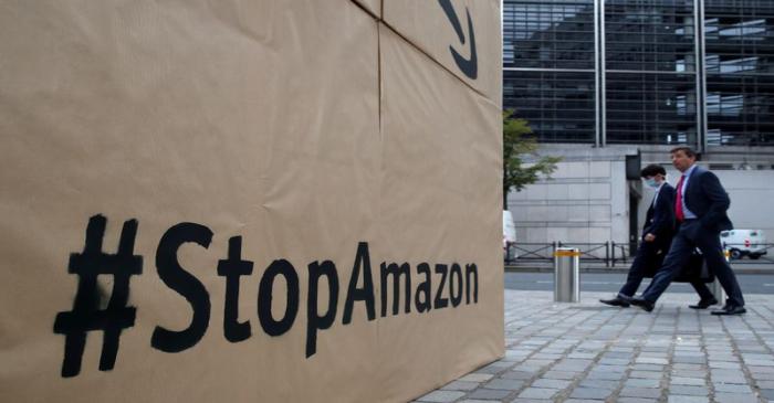 Climate activists attend a demonstration against Amazon near the Bercy Finance Ministry in