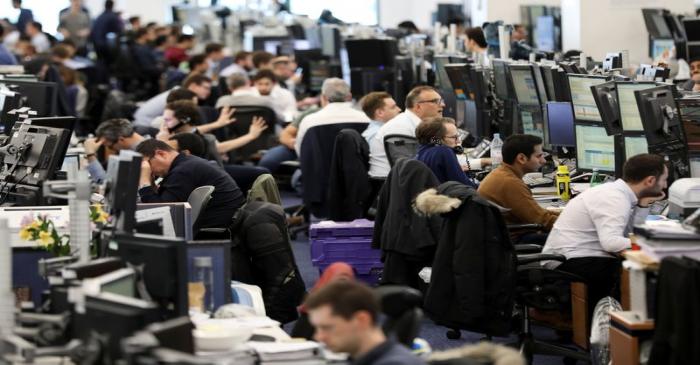 Traders work on the trading floor of Barclays Bank at Canary Wharf in London