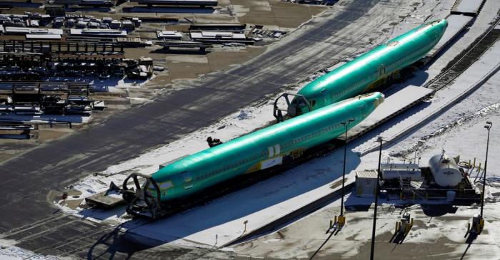 Airplane fuselages bound for Boeing's 737 Max production facility await shipment on rail