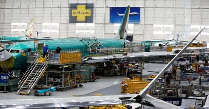 FILE PHOTO: People work near the door of a 737 Max aircraft at the Boeing factory in Renton