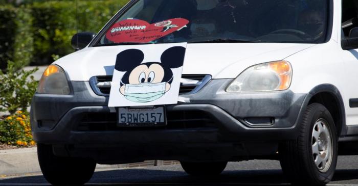 Disney cast members stage a car caravan outside Disneyland California, calling for higher