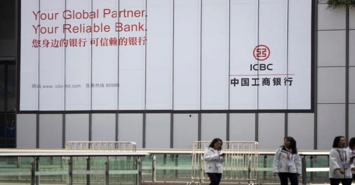 FILE PHOTO:  People walk past a sign of the Industrial and ICBC at the venue for the second