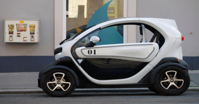 A Renault Twizy battery-powered electric car is parked on a street in Vienna