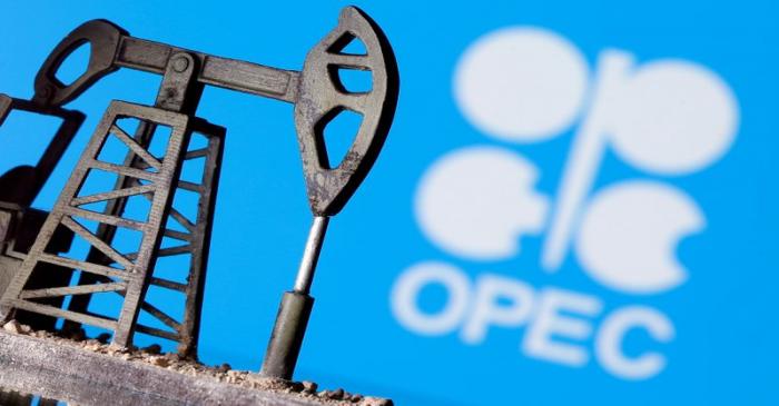 FILE PHOTO: A 3D printed oil pump jack is seen in front of displayed Opec logo in this