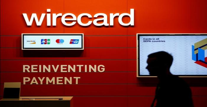 FILE PHOTO: A man walks past the Wirecard booth at the computer games fair Gamescom in Cologne,