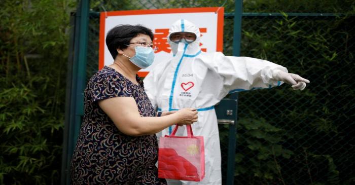 People receive nucleic acid tests, during a government-organised visit to a testing site,