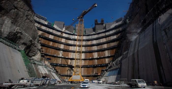 FILE PHOTO: Crane is seen near the dam of Wudongde hydropower plant under construction, on the