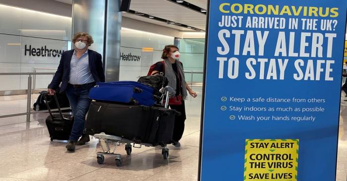 Passengers arrive at Heathrow Airport, as Britain launches its 14-day quarantine for