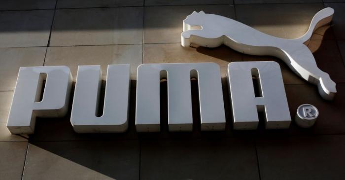 The logo of German sports goods firm Puma is seen at the entrance of one of its stores in