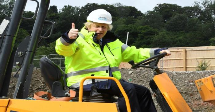 Britain's Prime Minister Boris Johnson gestures visits the Speller Metcalfe's building site in
