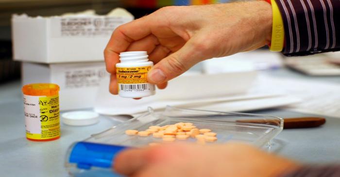 FILE PHOTO: Pharmacist Jim Pearce fills a Suboxone prescription at Boston Healthcare for the