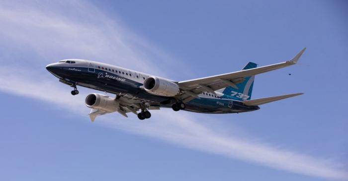 A Boeing 737 MAX airplane lands after a test flight at Boeing Field in Seattle