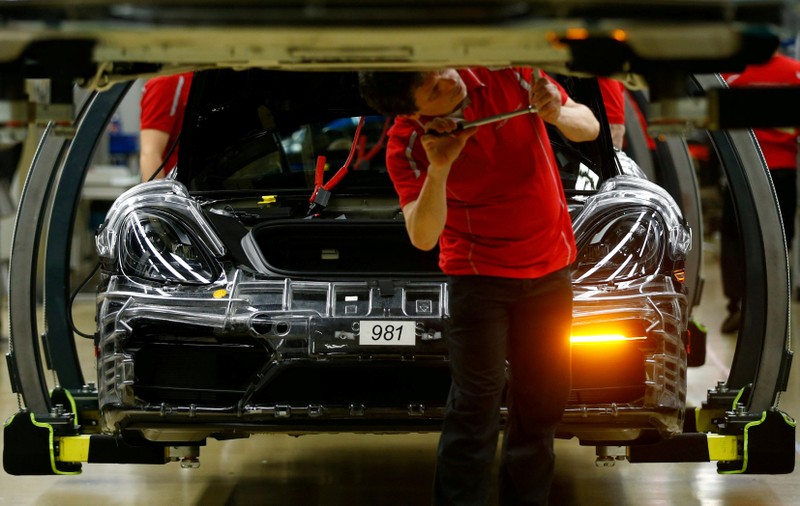FILE PHOTO: An employee of German car manufacturer Porsche works at the Porsche factory in