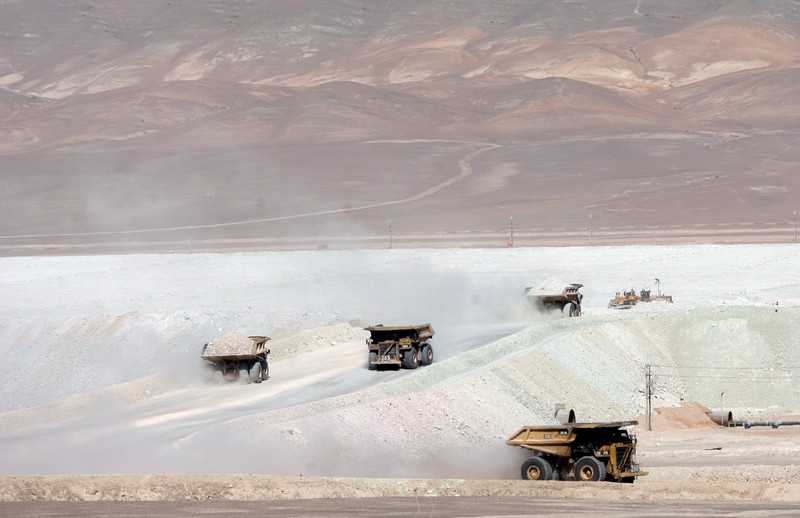FILE PHOTO: Trucks travel along a road in the La Escondida copper mine near Antofagasta