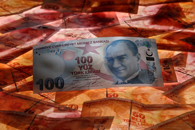 FILE PHOTO: A 100 Turkish lira banknote is seen on top of 50 Turkish lira banknotes in this