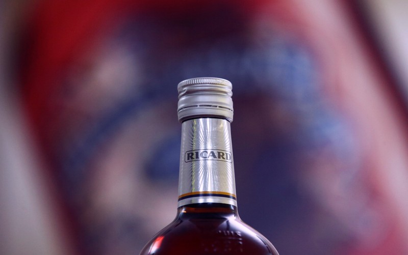 A logo is seen on a bottle of the Ricard aniseed-flavoured beverage displayed during French