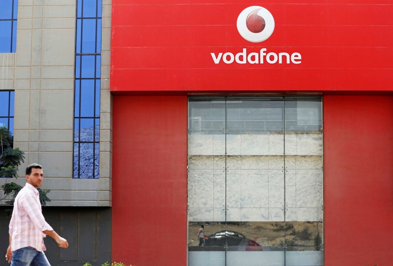 A man walks past Vodafone Egypt Telecommunications Co in the Cairo
