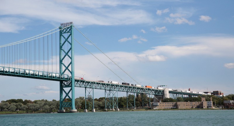 Commercial trucks are seen crossing over the Ambassador Bridge into Windsor, Ontario from