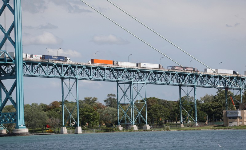 Commercial trucks are seen crossing over the Ambassador Bridge into Windsor, Ontario from