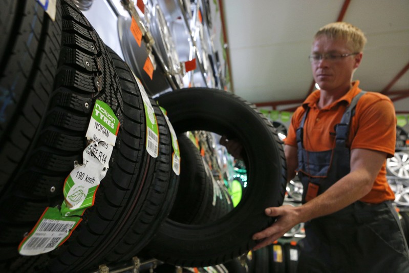 An employee sorts Nokian tyres at a tyre assembling centre and shop in Moscow