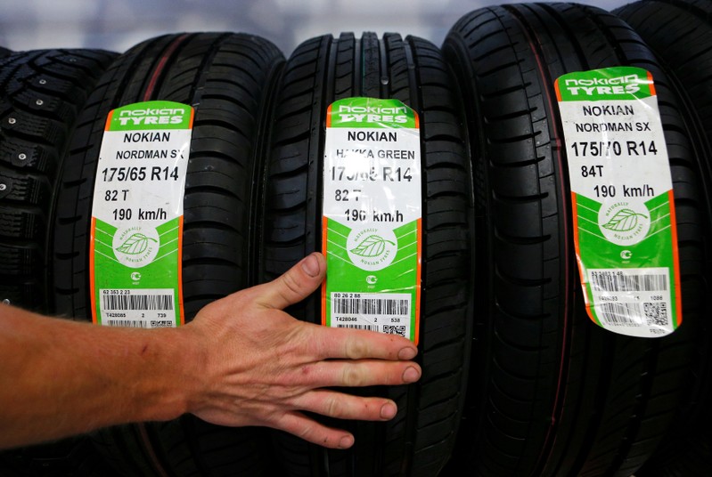 FILE PHOTO: An employee sorts Nokian tyres at a tyre assembling centre and shop in Moscow