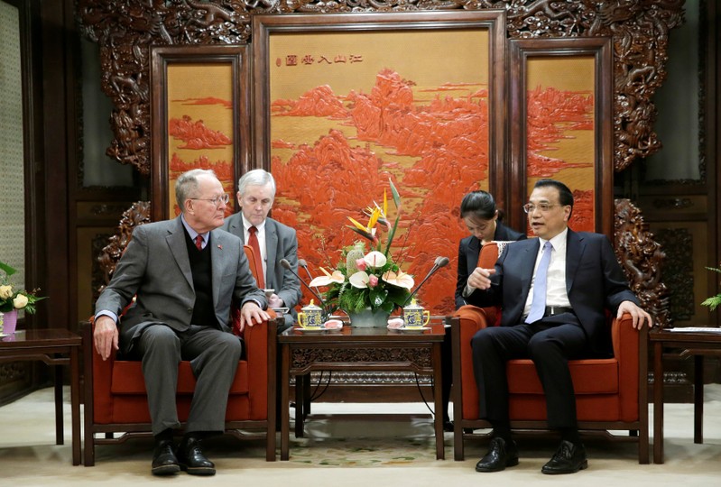 China's Premier Li Keqiang speaks next to Tennessee Senator Lamar Alexander during a meeting