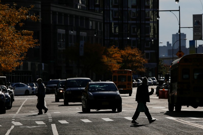 People walk along a local street in Long Island City, where Amazon.com is reportedly