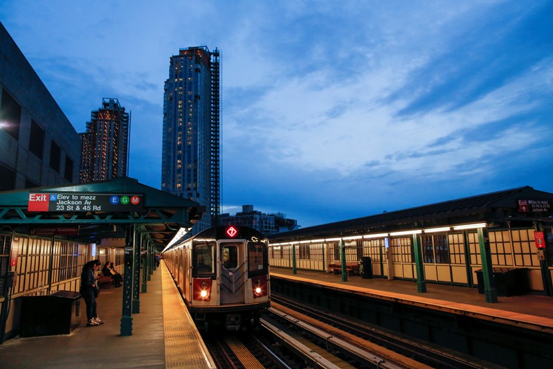 People wait the arrival of 7 train in Long Island City, where Amazon.com is reportedly