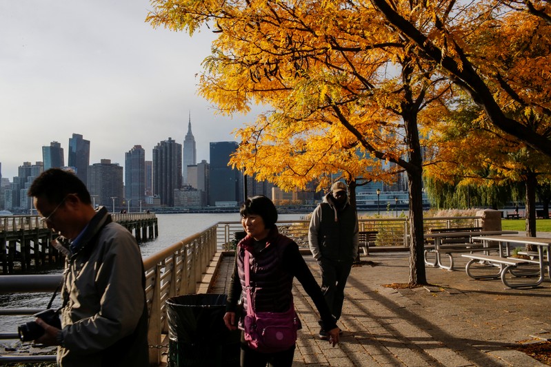 People walk along Gantry Plaza State Park, in Long Island City, where Amazon.com is reportedly